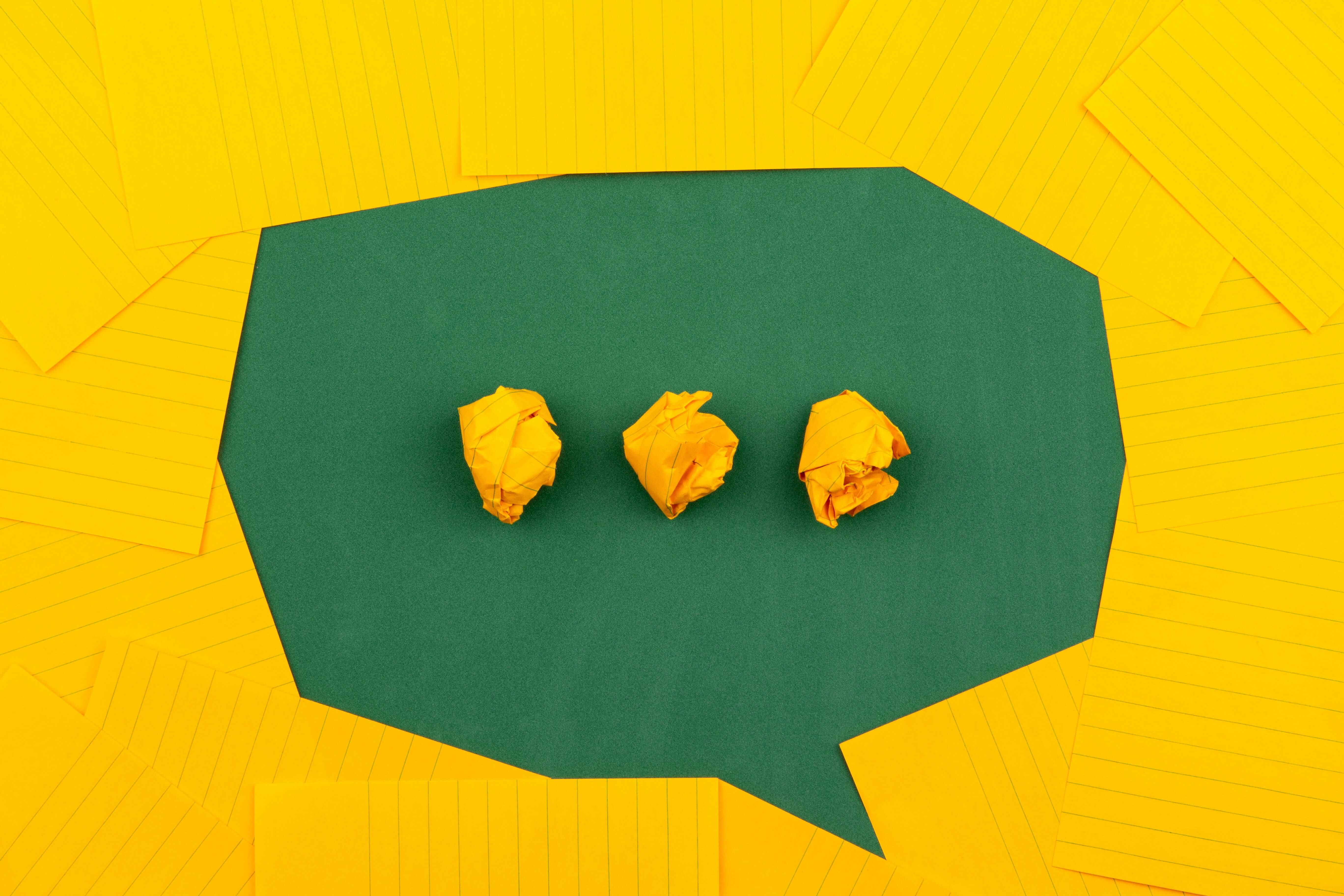 A shape of message bubble formed by yellow colored pages